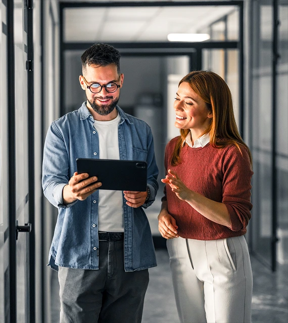 Man and woman looking at ipad