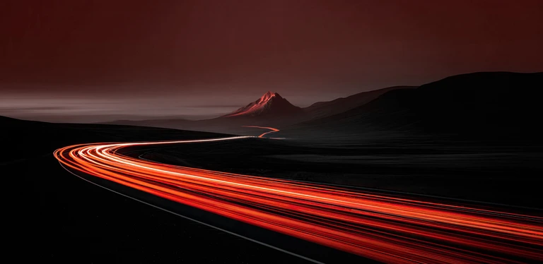 long exposure shot of road with volcano in background with all dark