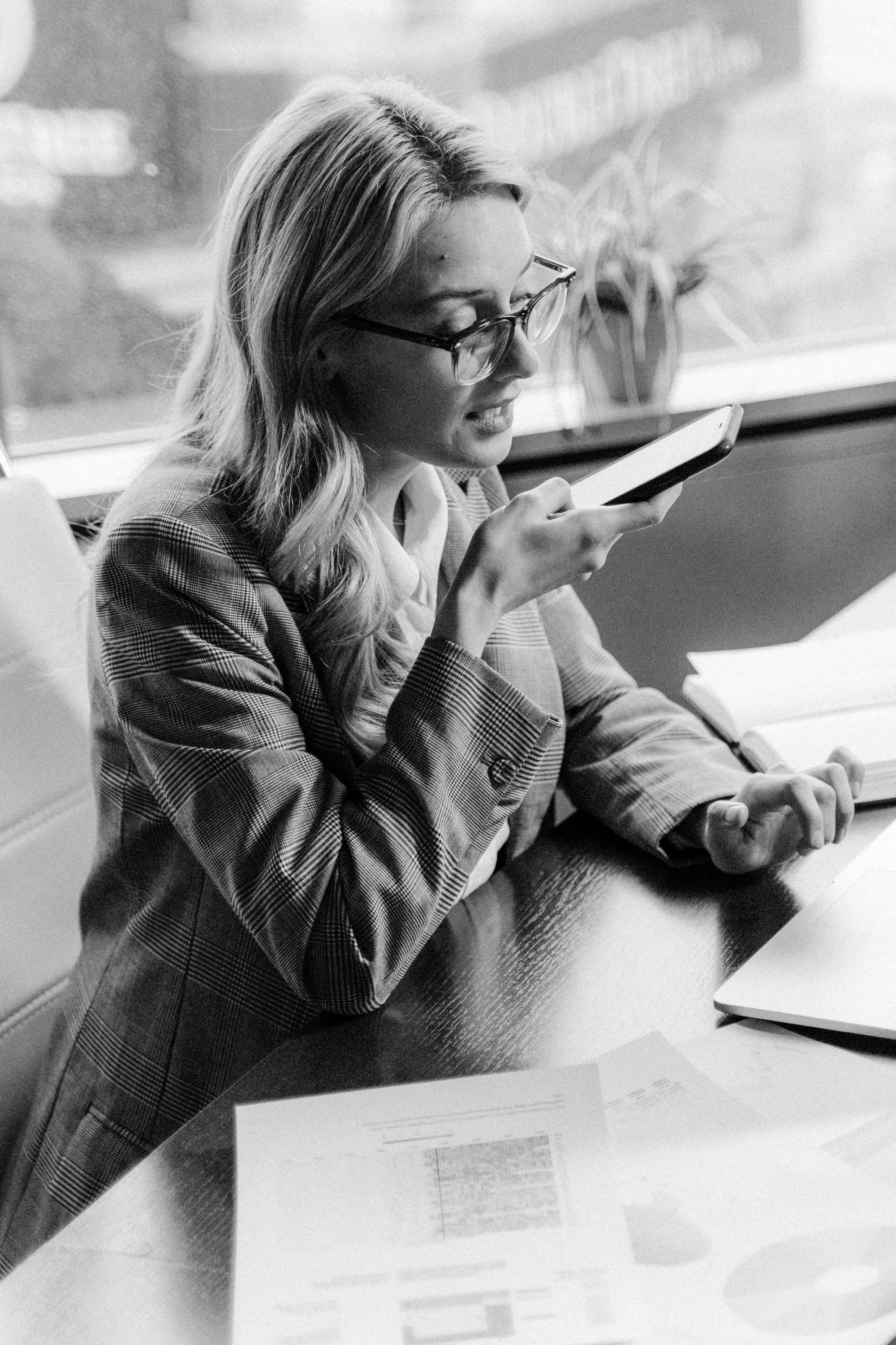 woman speaking on a phone in office attire