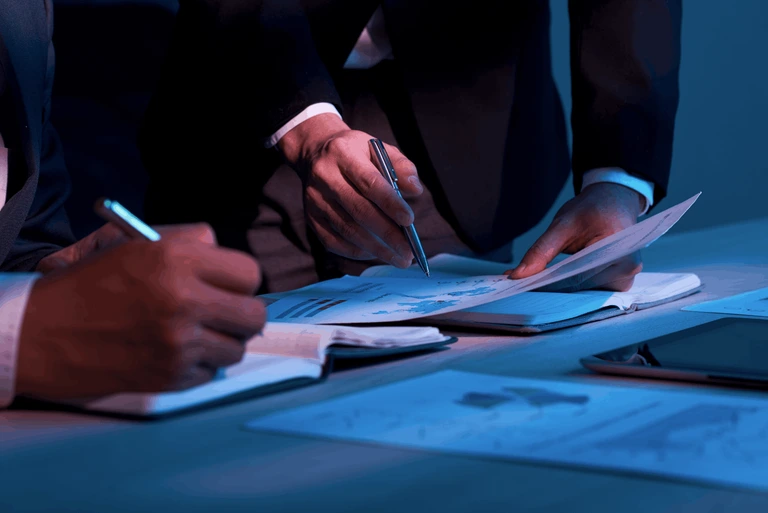 man signing papers in a financial service